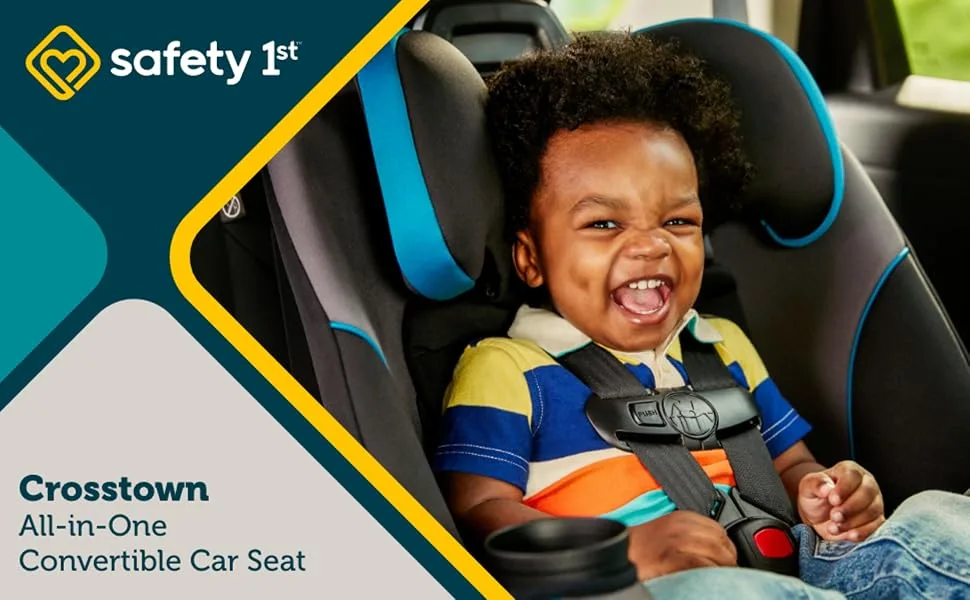 4b3f5ffe-6031-4d15-8d31-343b2d838938.__CR0,0,1940,1200_PT0_SX970_V1___ | Babyz Corner Toddler smiling in a blue-trimmed Safety 1st Crosstown all-in-one convertible car seat, buckled into a car in an ad image.